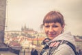 Close-up portrait of young girl traveler looking at camera and smile, Prague Castle Royalty Free Stock Photo