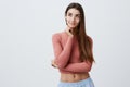 Close up portrait of young handsome charming caucasian student girl with long brown hair in pink shirt and blue shorts Royalty Free Stock Photo