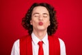 Close up portrait of young handsome guy teenager in formal suit vest and necktie plump lips wanna kisses isolated on red