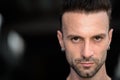 Close-up portrait of young handsome man face outdoors looking at camera Royalty Free Stock Photo