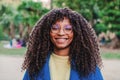 Close up portrait of young happy african american woman wearing goggles smiling looking at camera in a park outdoors Royalty Free Stock Photo