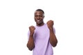 close-up portrait of young happy american man in lilac t-shirt on white background Royalty Free Stock Photo