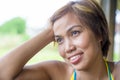 Close up portrait of young happy beautiful Asian woman from Indonesia looking thoughtful and pensive daydreaming and thinking Royalty Free Stock Photo