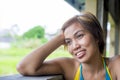 Close up portrait of young happy beautiful Asian woman from Indonesia looking thoughtful and pensive daydreaming and thinking Royalty Free Stock Photo