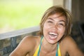 Close up portrait of young happy and beautiful expressive Asian woman laughing excited and nice in positive face expression