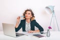 Close up portrait Young happy business woman sitting at her desk in an office.working on a laptop computer,planning a new project. Royalty Free Stock Photo