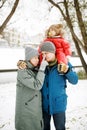 Close-up portrait of young happy family with one toddler in winter casual outfit posing outdoors Royalty Free Stock Photo