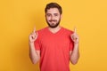 Close up portrait of young happy man with good idea, pointing up with index fingers, looking smiling directly at camera, wearing Royalty Free Stock Photo