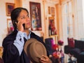 Close up portrait of young indigenous man wearing hat and poncho using cell phone Royalty Free Stock Photo