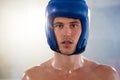 Close-up portrait of young male boxer wearing blue headgear