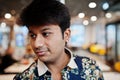 Close up portrait of young male indian freelancer in fast food cafe, handsome head of asian man wear in shirt at comfortable