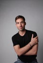 Vertical portrait of young man with serious face expression. White background. Royalty Free Stock Photo