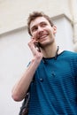 Close up young man smiling and talking with mobile phone outdoors Royalty Free Stock Photo