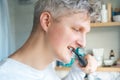 Close up portrait of Young Man is using electric ultrasound toothbrush. Male brushing teeth. Daily dental hygiene and Royalty Free Stock Photo