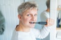 Close up portrait of Young Man is using electric ultrasound toothbrush. Male brushing teeth. Daily dental hygiene and Royalty Free Stock Photo