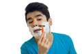 A close-up portrait of young man who stands with foam on your face and shaves his beard Royalty Free Stock Photo