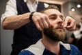 Young man at barber shop being prepared for shaving Royalty Free Stock Photo