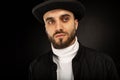 Close up portrait of young model male with beard in black hat Royalty Free Stock Photo