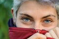 close-up portrait of a young non-binary person with blue eyes looking at camera. Gender identity