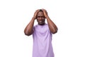 close-up portrait of a young pensive african man in a lilac t-shirt worried Royalty Free Stock Photo