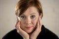 Close up portrait of young red hair sweet and beautiful Caucasian woman looking to the camera relaxed and tranquil smiling happy Royalty Free Stock Photo