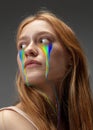 Portrait of young beautiful woman with neon, fluid tears from eyes. Concept of fashion and beauty, emotions and feelings