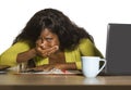 Close up portrait of young sad and depressed black afro American business woman crying while working at office computer desk feeli Royalty Free Stock Photo