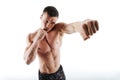 Close-up portrait of young shirtless boxer posing with outstretched hand