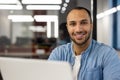 Close-up portrait of young smiling male freelancer and student working and studying in modern office, sitting at laptop Royalty Free Stock Photo