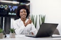 Close up portrait of young smiling successful African American business woman, posing to camera with her thumb up, while Royalty Free Stock Photo