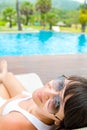 Close-up portrait of young smiling woman with a sunglasses lying Royalty Free Stock Photo