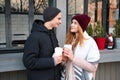 Stylish couple in love holding takeout coffee cup in hands Royalty Free Stock Photo