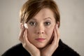 Close up portrait of young sweet and pretty red hair woman looking sad and depressed in dramatic face expression feeling lonely Royalty Free Stock Photo