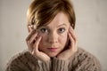 Close up portrait of young sweet and pretty red hair woman looking sad and depressed in dramatic face expression feeling lonely Royalty Free Stock Photo