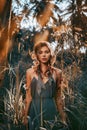 Close up portrait of young and tender woman on a feild at sunset