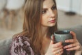 Close up portrait of young thoughtful woman with cup of tea or coffee Royalty Free Stock Photo
