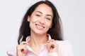 Close-up portrait of a young very beautiful woman with a charming toothy smile, black hair and brown eyes on a white background in Royalty Free Stock Photo