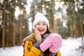 Young woman in pine forest during the winter