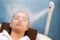 Young woman having thermal steam treatment on face Royalty Free Stock Photo