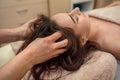 Close up portrait of young woman having head massage at spa. Royalty Free Stock Photo