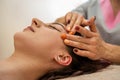 Close up portrait of young woman having head massage at spa. Royalty Free Stock Photo