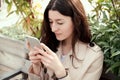 Close up portrait of young woman holding smartphone in her hands Royalty Free Stock Photo