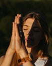 Close Up Portrait Young Woman Practicing Yoga and Meditation with Folded Hands Outdoors at Sunset Royalty Free Stock Photo