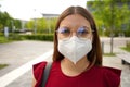 Close up portrait of young woman wearing glasses and protective mask KN95 FFP2 outside Royalty Free Stock Photo