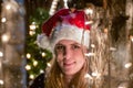 Close up portrait of young woman who look at camera, with santa