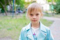 Close up portrait of young 6-7 year old girl. Girl 7 years old outdoors portrait in a blue jacket Royalty Free Stock Photo