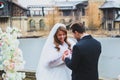 Close-up portraits of stylish newlyweds on the territory of country hotel