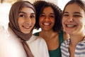 Close up portraits of three smiling teenage girls. Muslim in a hijab, african american and white friends females Royalty Free Stock Photo