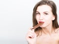 Close-up portret of beautiful woman with red lips eating chocolate Royalty Free Stock Photo