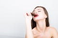 Close-up portret of beautiful woman with red lips eating chocolate Royalty Free Stock Photo